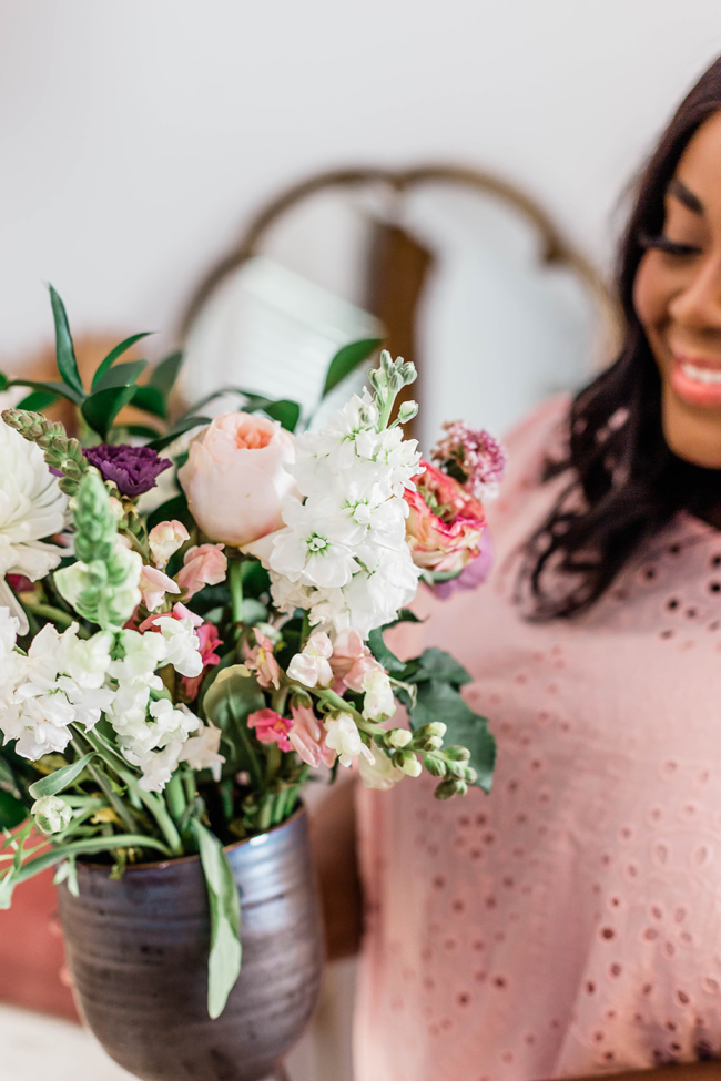 woman working from home at desk, UrbanStems, Flower Delivery, Fresh Florals, Black Girl Arranging Flowers, Black woman decorating in her home, Flower arranging